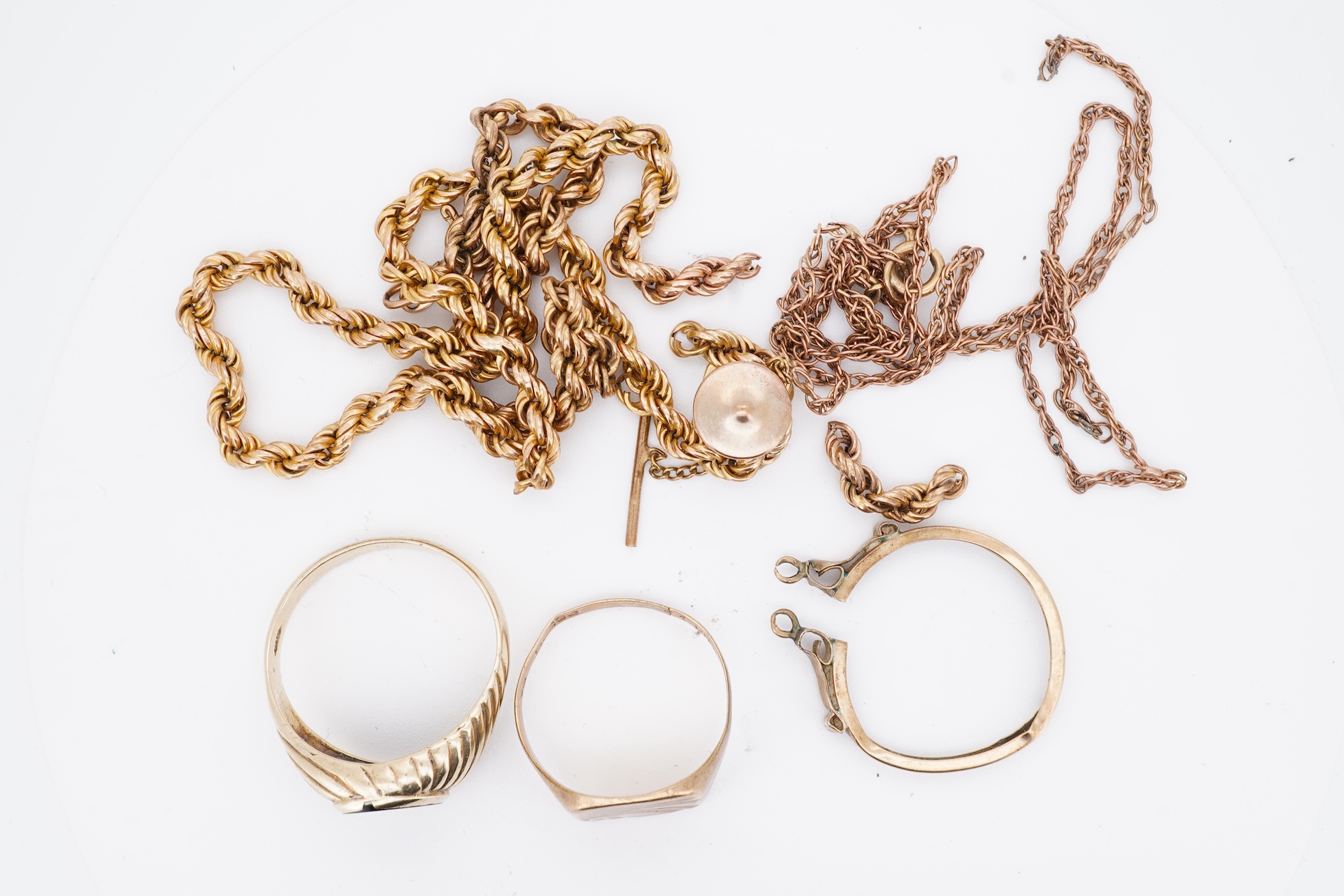 A 1960's 9ct gold and black onyx set signet ring, size X, one other 9ct gold signet ring, a 9ct gold dress stud, a 9ct gold pendant mount and two damaged 9k necklaces, gross weight 21 grams.